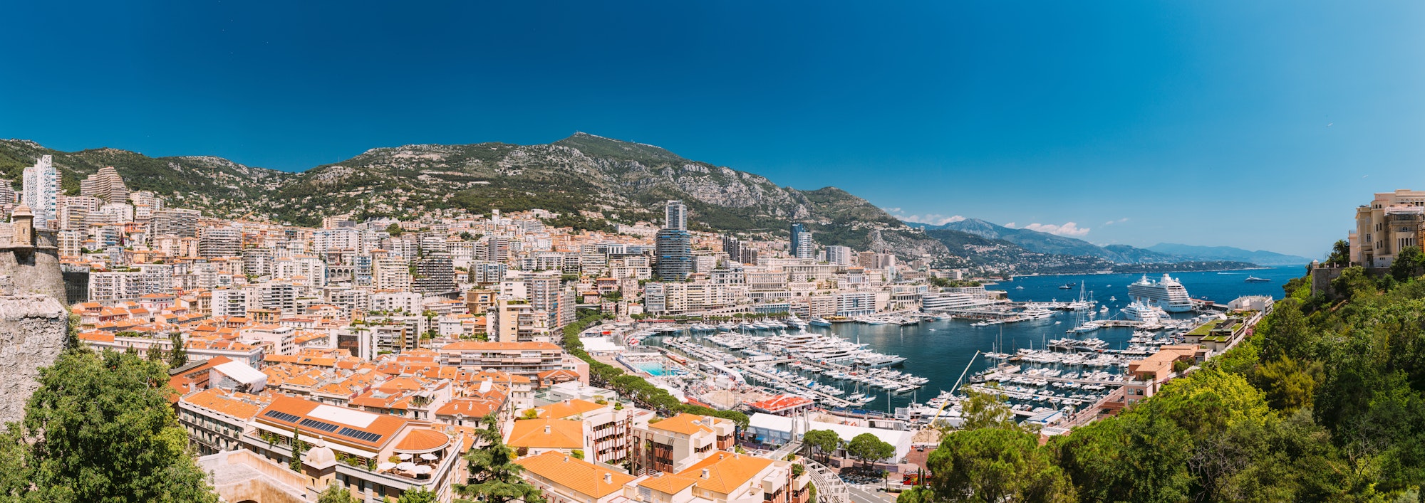 Monaco, Monte Carlo cityscape. Real estate architecture on mountain hill background. Many high-rise